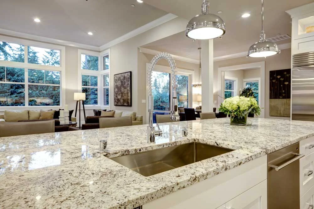 Custom polished granite kitchen island countertop with eased edge profile and stainless undermount sink installed in Salt Lake City, Utah