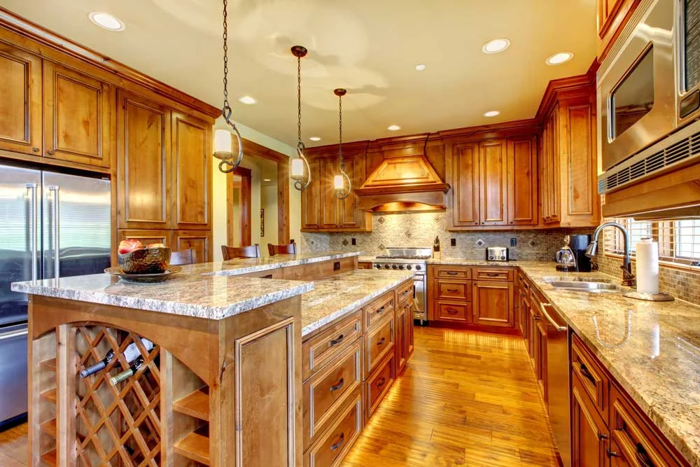 Custom Giallo Ornamental granite two-tier kitchen island and countertops installed in Sandy, Utah